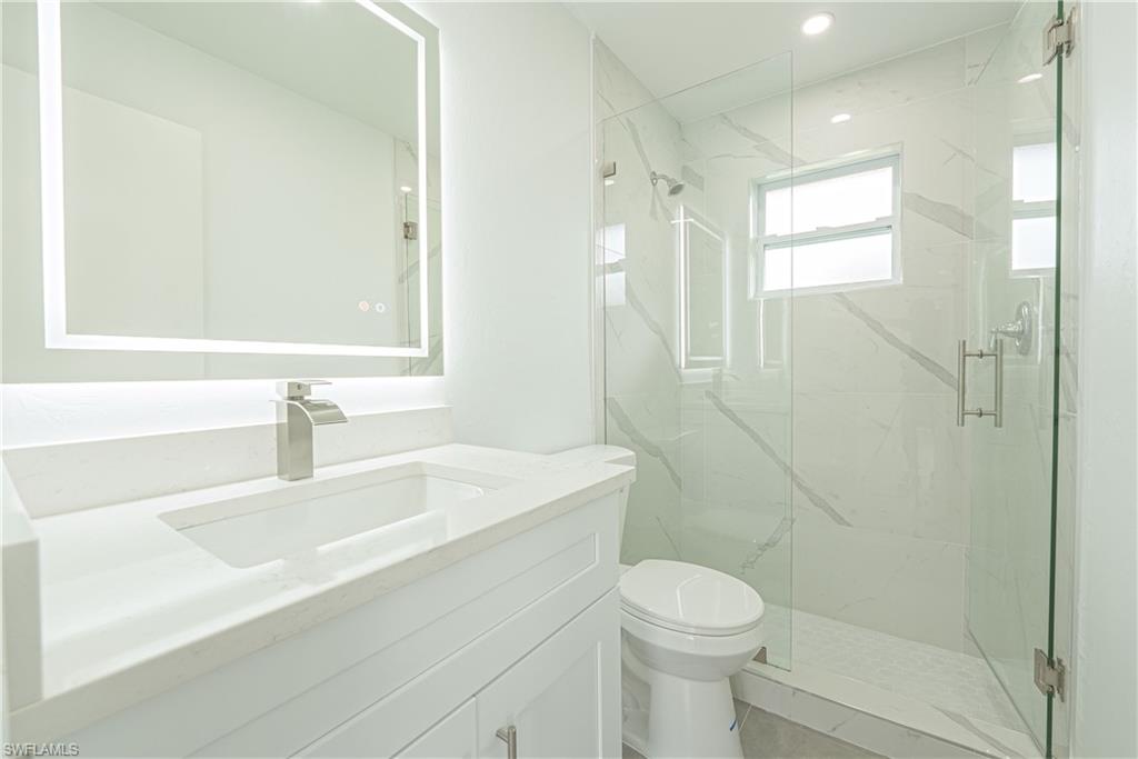 7233 Coolidge Road Fort Myers, FL 33967 - Photo 23 of 36 a bathroom with a sink a toilet and shower