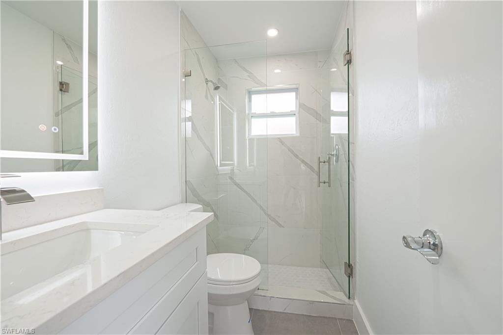 7233 Coolidge Road Fort Myers, FL 33967 - Photo 24 of 36 a bathroom with a sink a toilet and shower