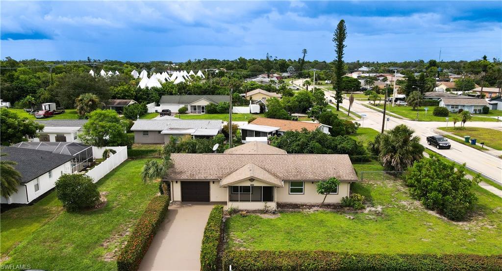 7233 Coolidge Road Fort Myers, FL 33967 - Photo 33 of 36 a aerial view of a house with a yard and lake view