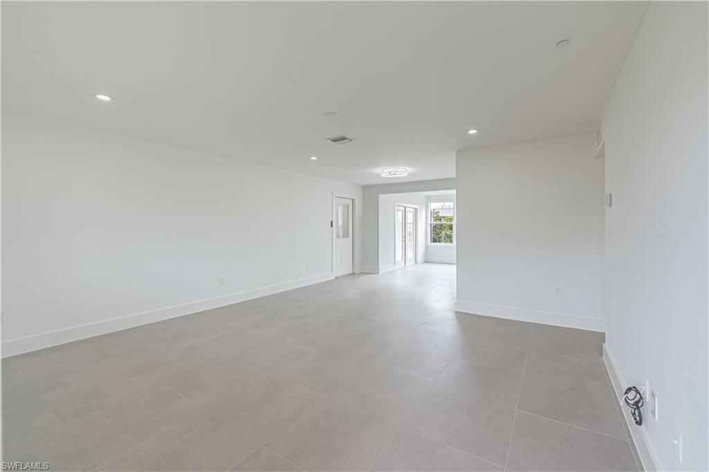 7233 Coolidge Road Fort Myers, FL 33967 - Photo 6 of 36 a view of an empty room with wooden floor and a window