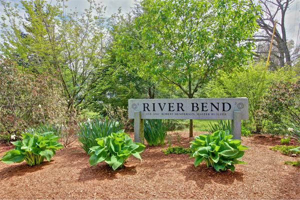 9 Riverbend Road Upton, MA 01568 - Photo 2 of 30 a sign that is sitting in front of flowers