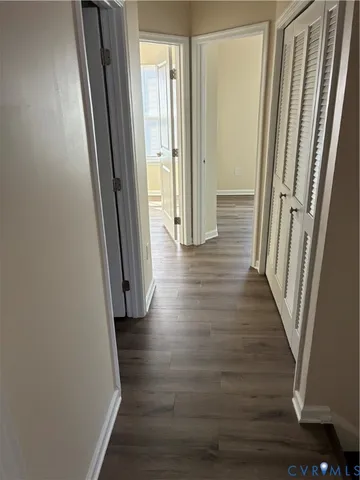 a bathroom with a sink a mirror and wooden floor
