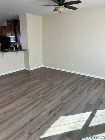 a view of a kitchen with wooden floor and stainless steel appliances