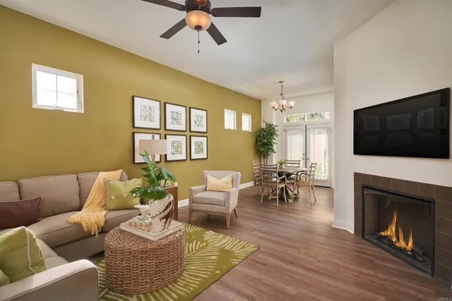 a living room with furniture fireplace and flat screen tv