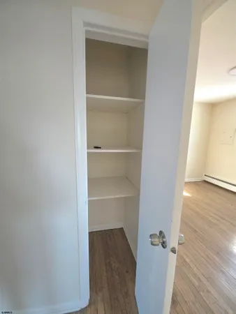 a view of a room with wooden floor
