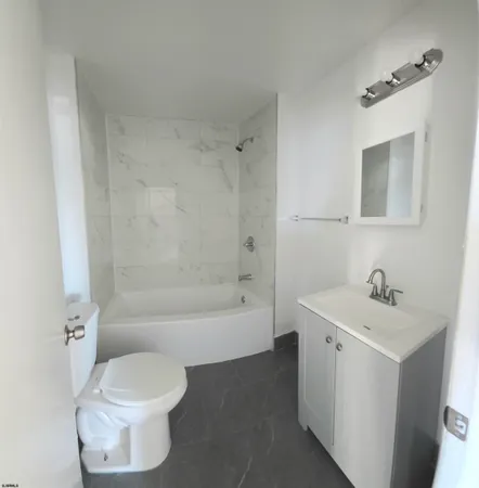 a bathroom with a sink toilet and bathtub