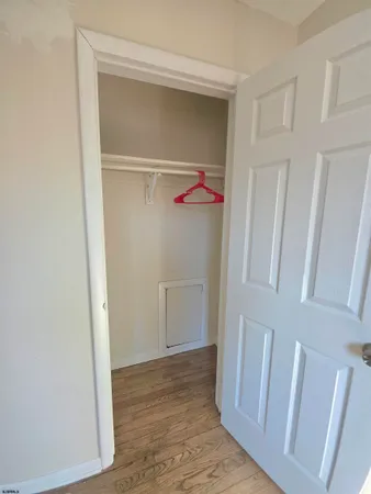 a view of walk in closet with white walls