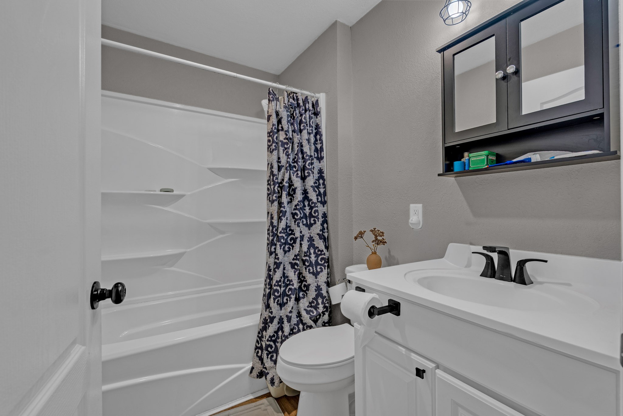 921 Barney Holt Road Jamestown, TN 38556 - Photo 11 of 24 a bathroom with a sink a toilet and a shower curtain