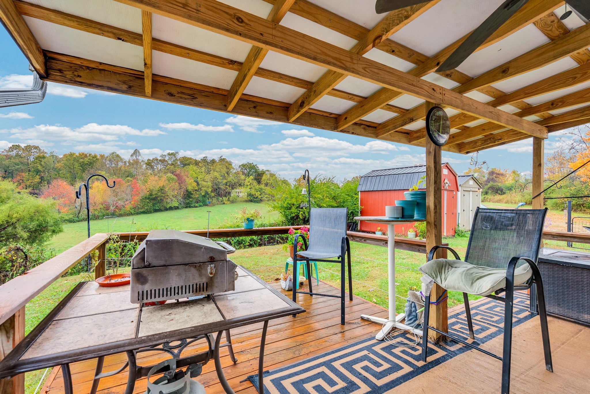 921 Barney Holt Road Jamestown, TN 38556 - Photo 18 of 24 a patio with glass top table and chairs