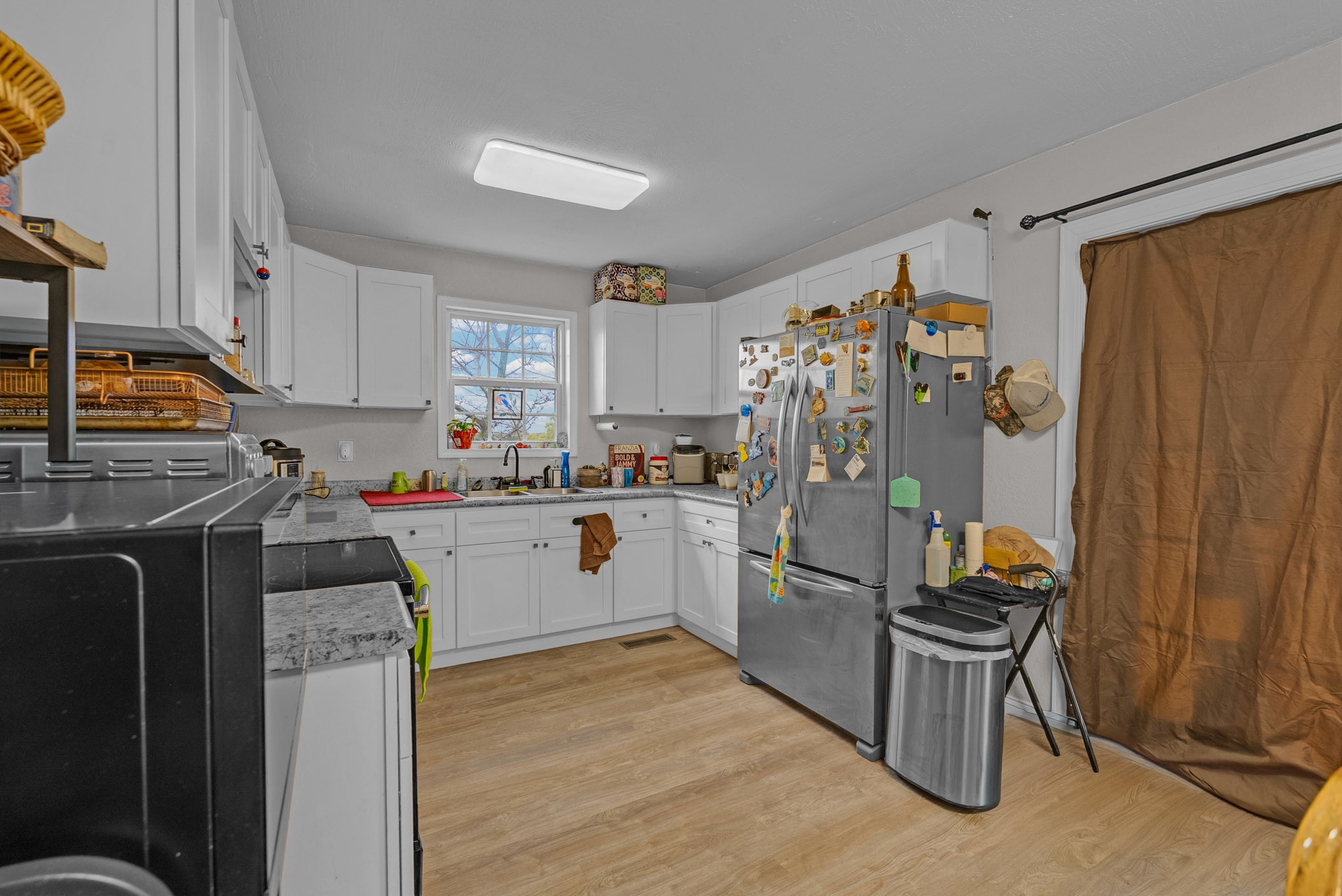 921 Barney Holt Road Jamestown, TN 38556 - Photo 3 of 24 a kitchen with stainless steel appliances granite countertop a refrigerator stove and sink
