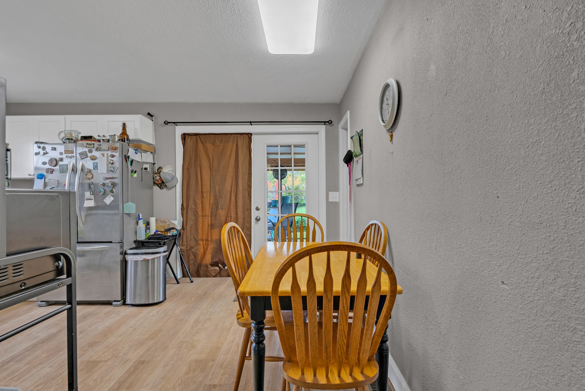 921 Barney Holt Road Jamestown, TN 38556 - Photo 4 of 24 a dining room with furniture a chandelier and wooden floor
