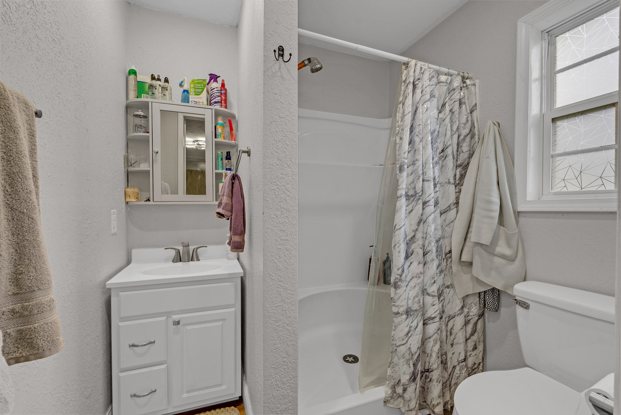 921 Barney Holt Road Jamestown, TN 38556 - Photo 10 of 24 a bathroom with a sink a toilet and shower curtain