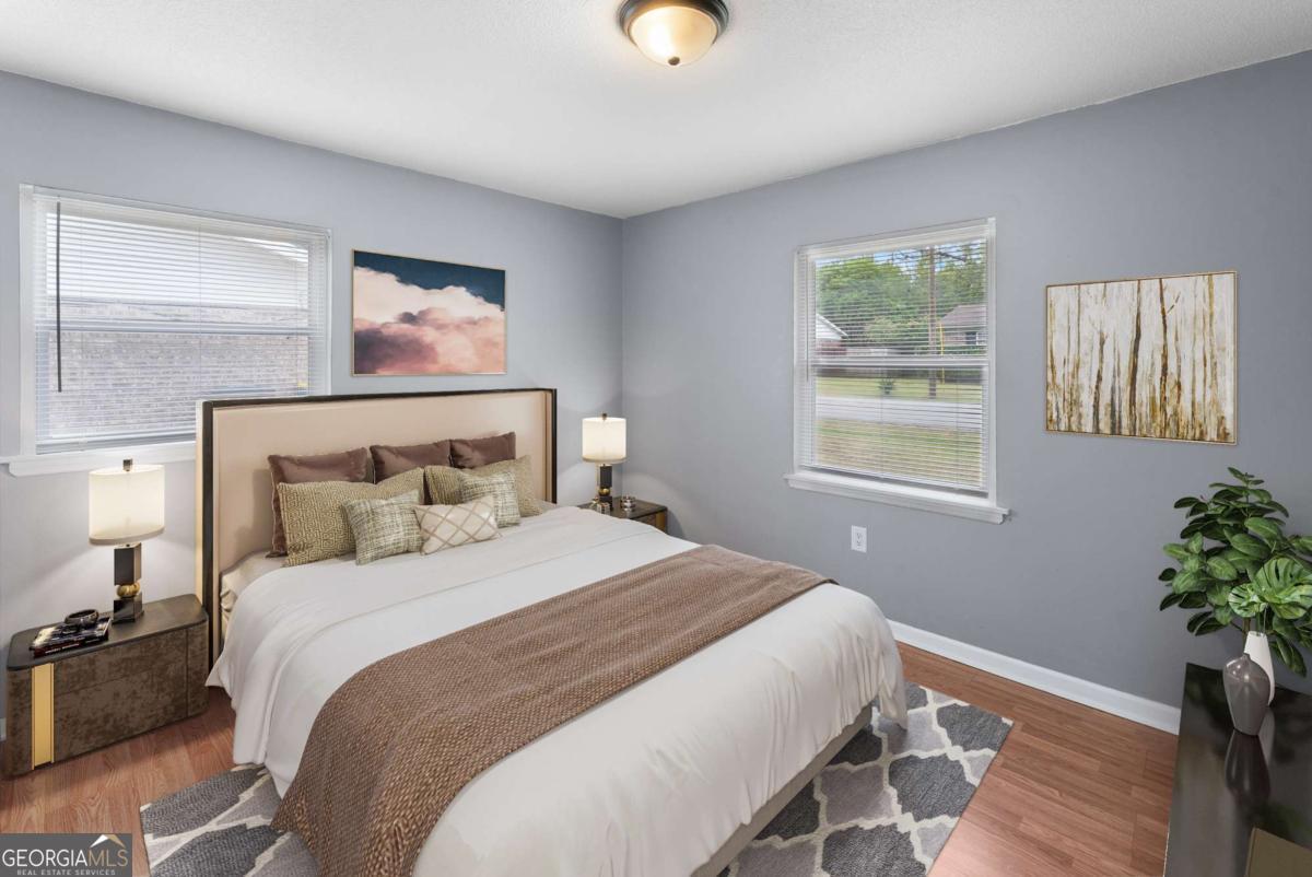 320 West Whatley Street Pooler, GA 31322 - Photo 13 of 34 a bedroom with a bed and a potted plant