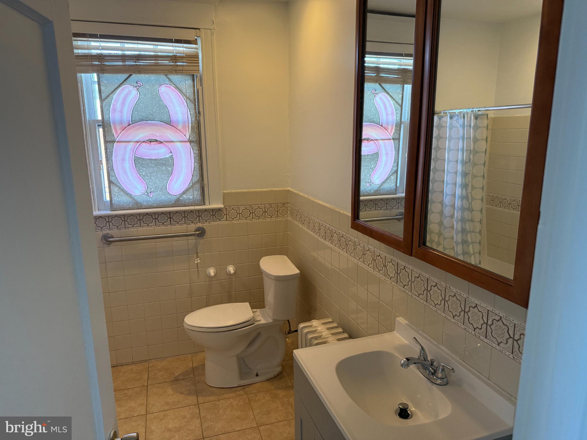 7735 Loretto Avenue Philadelphia, PA 19111 - Photo 15 of 19 a bathroom with a toilet sink and mirror