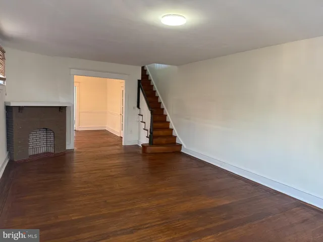 wooden floor in an empty room with a fireplace