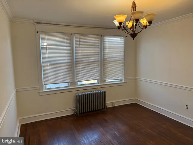 a view of a room with wooden floor and a window
