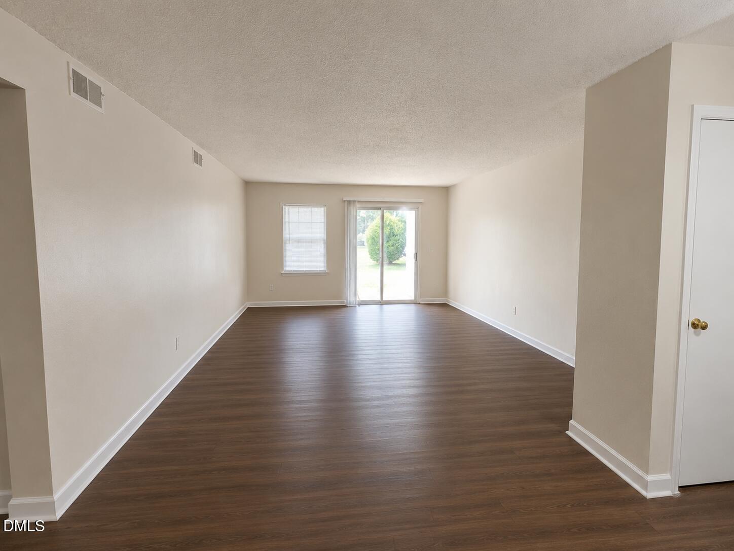 2506 Avent Ferry Road, Unit 101 Raleigh, NC 27606 - Photo 15 of 19 a view of an empty room with wooden floor and window