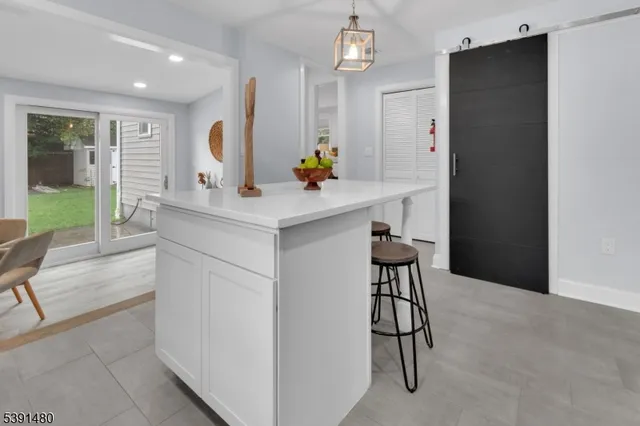 a kitchen with a table chairs refrigerator and cabinets