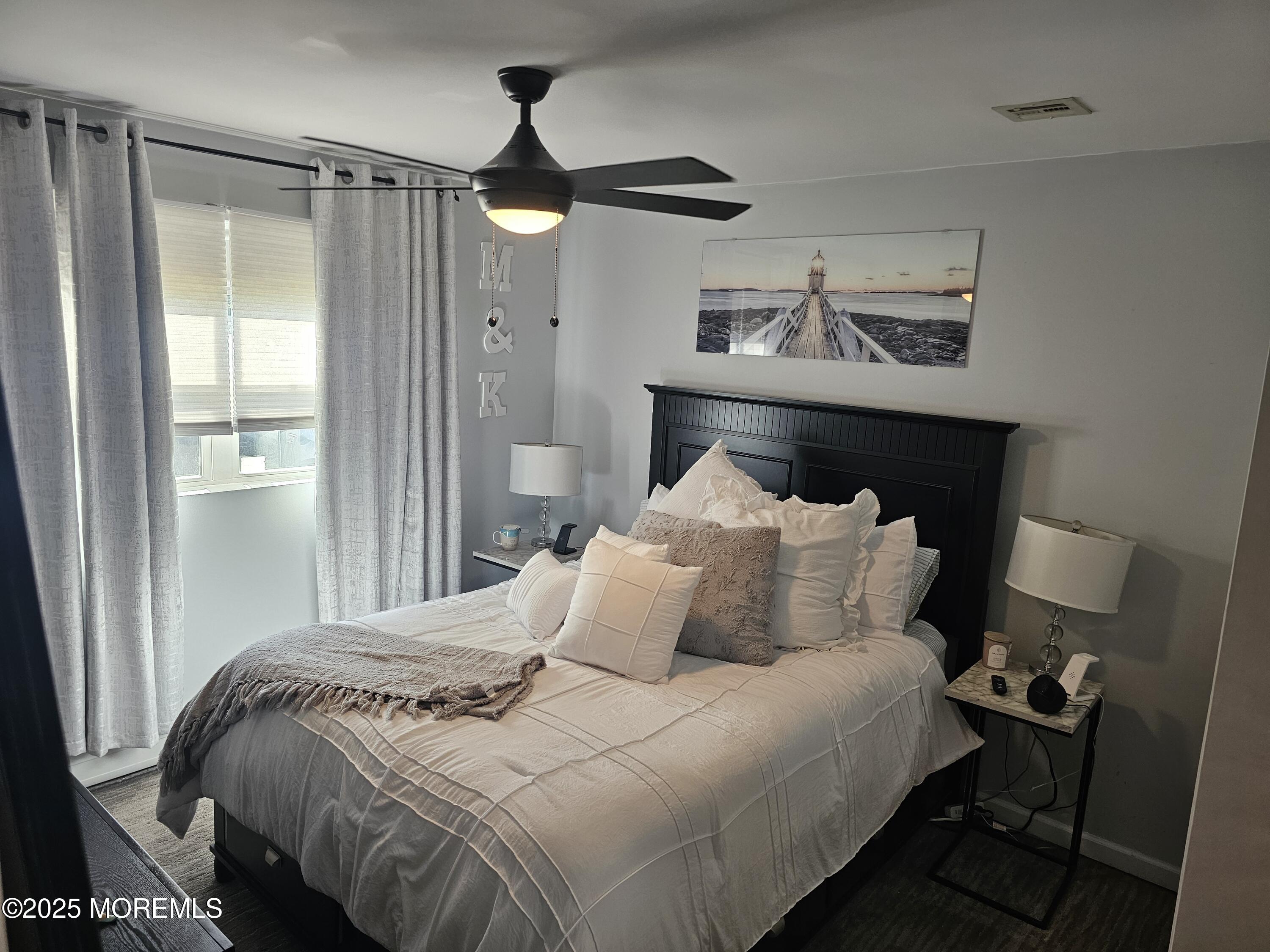 404 Bay Boulevard, Unit 2 Seaside Heights, NJ 08751 - Photo 12 of 16 a bedroom with a bed and a table in it