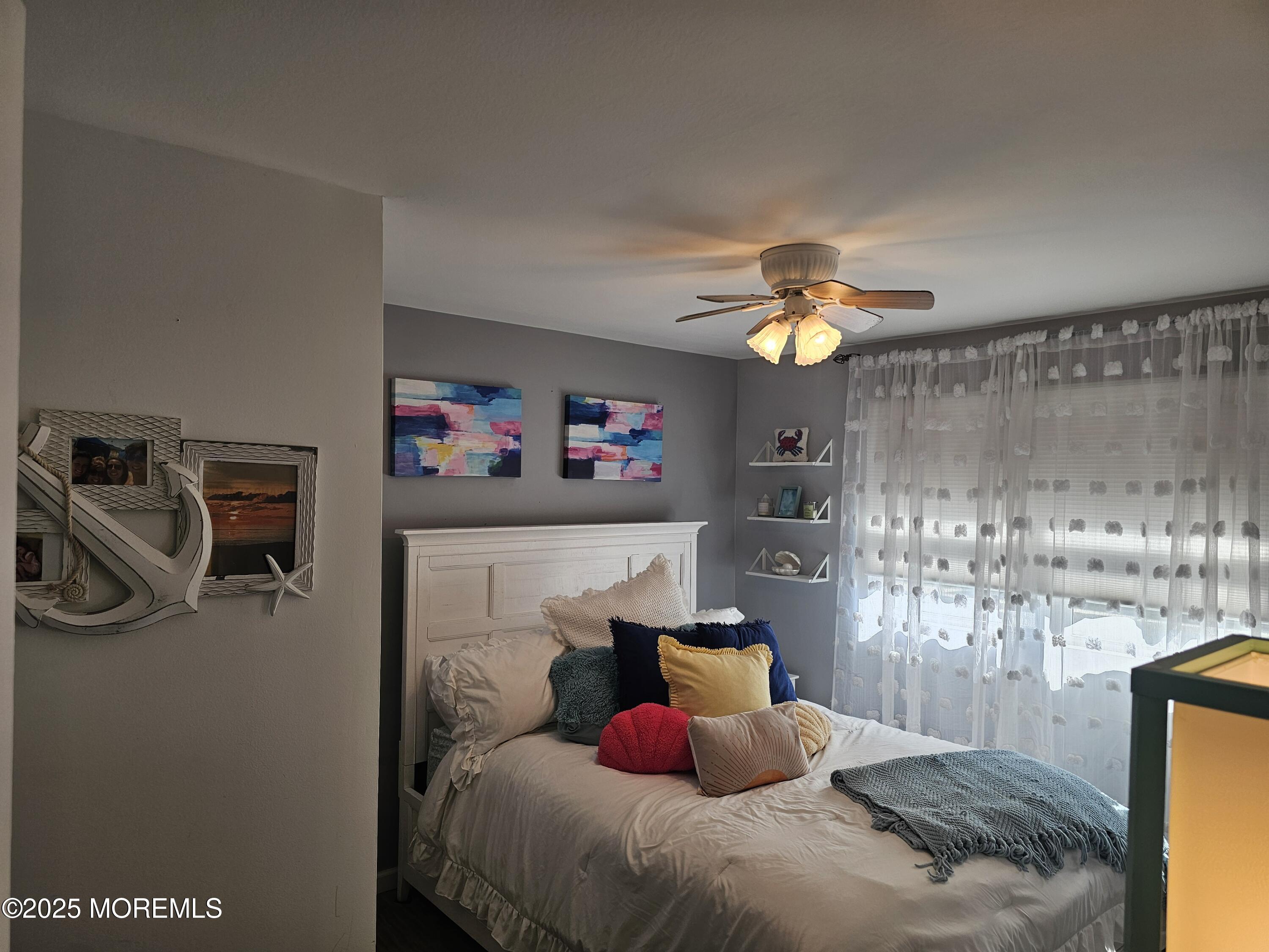 404 Bay Boulevard, Unit 2 Seaside Heights, NJ 08751 - Photo 13 of 16 a bedroom with a bed and a chandelier