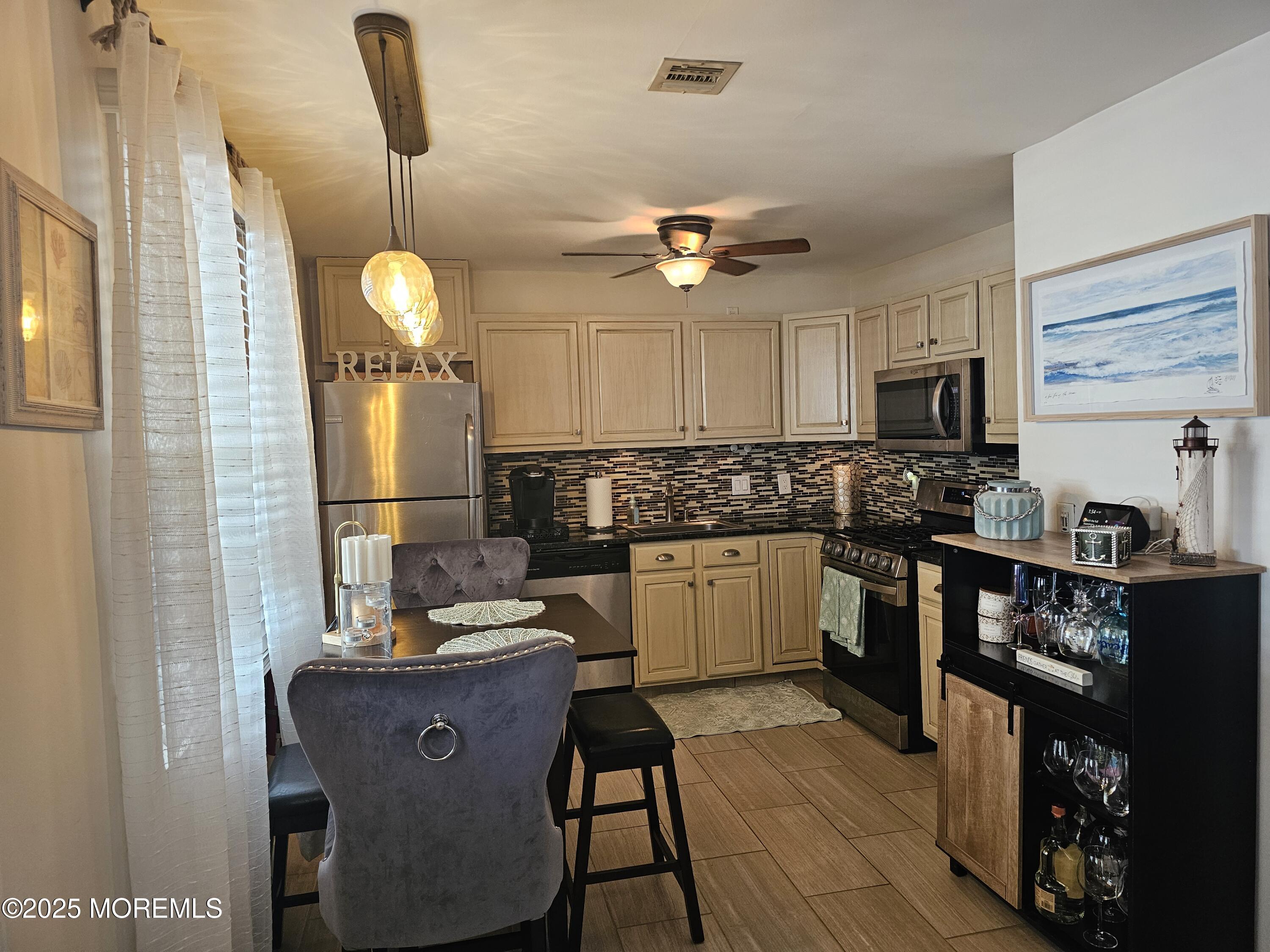 404 Bay Boulevard, Unit 2 Seaside Heights, NJ 08751 - Photo 5 of 16 a kitchen with granite countertop a sink appliances cabinets and furniture