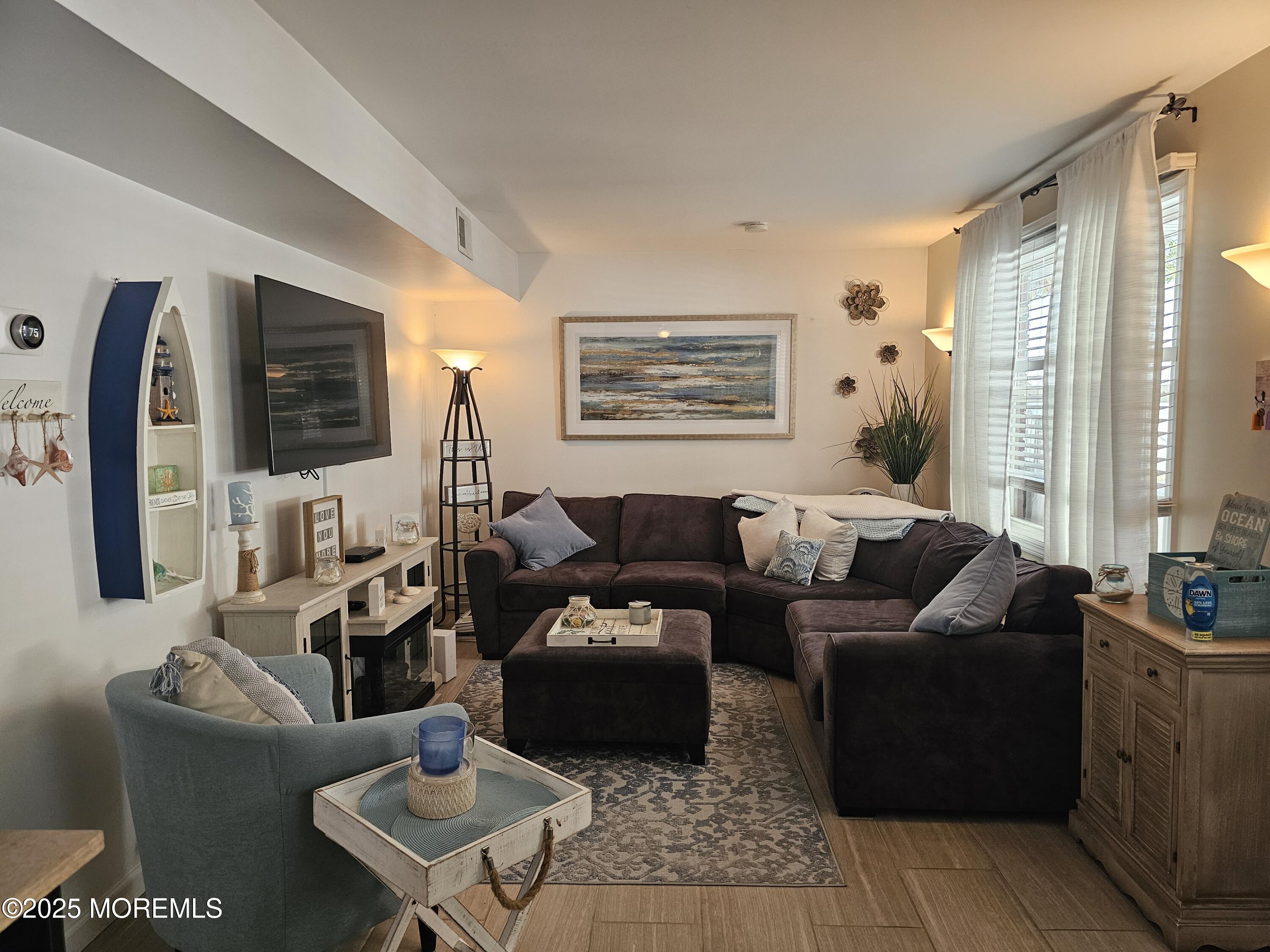 404 Bay Boulevard, Unit 2 Seaside Heights, NJ 08751 - Photo 7 of 16 a living room with furniture and a flat screen tv