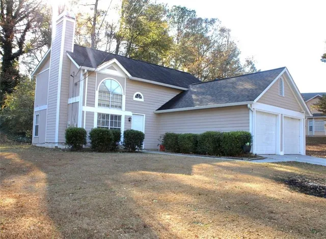 a front view of a house with a yard