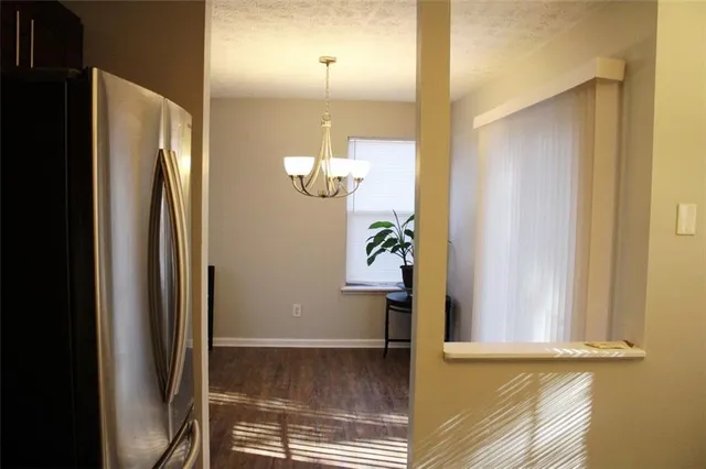 a view of a small space with wooden floor and a fan