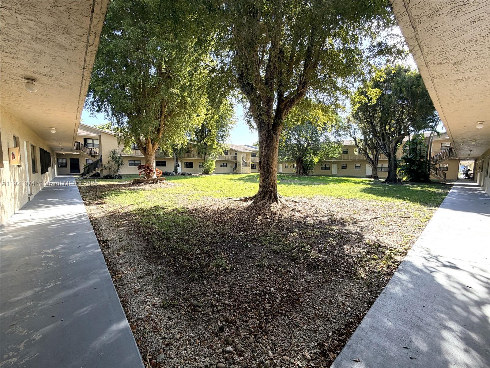 10350 Southwest 220th Street, Unit 143 Cutler Bay, FL 33190 - Photo 1 of 18 a view of a yard with basketball court