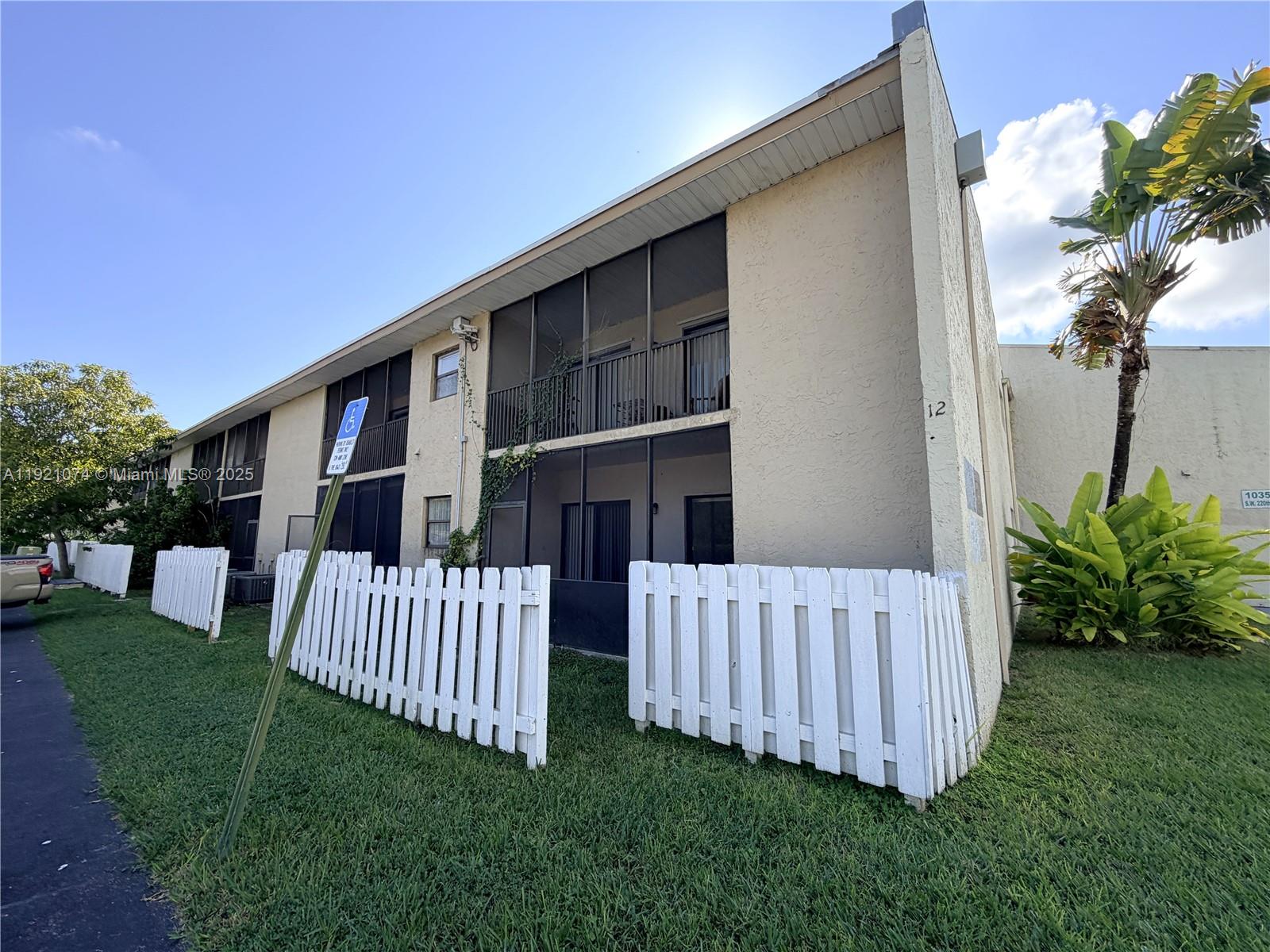 10350 Southwest 220th Street, Unit 143 Cutler Bay, FL 33190 - Photo 17 of 18 a view of a house with a yard and porch