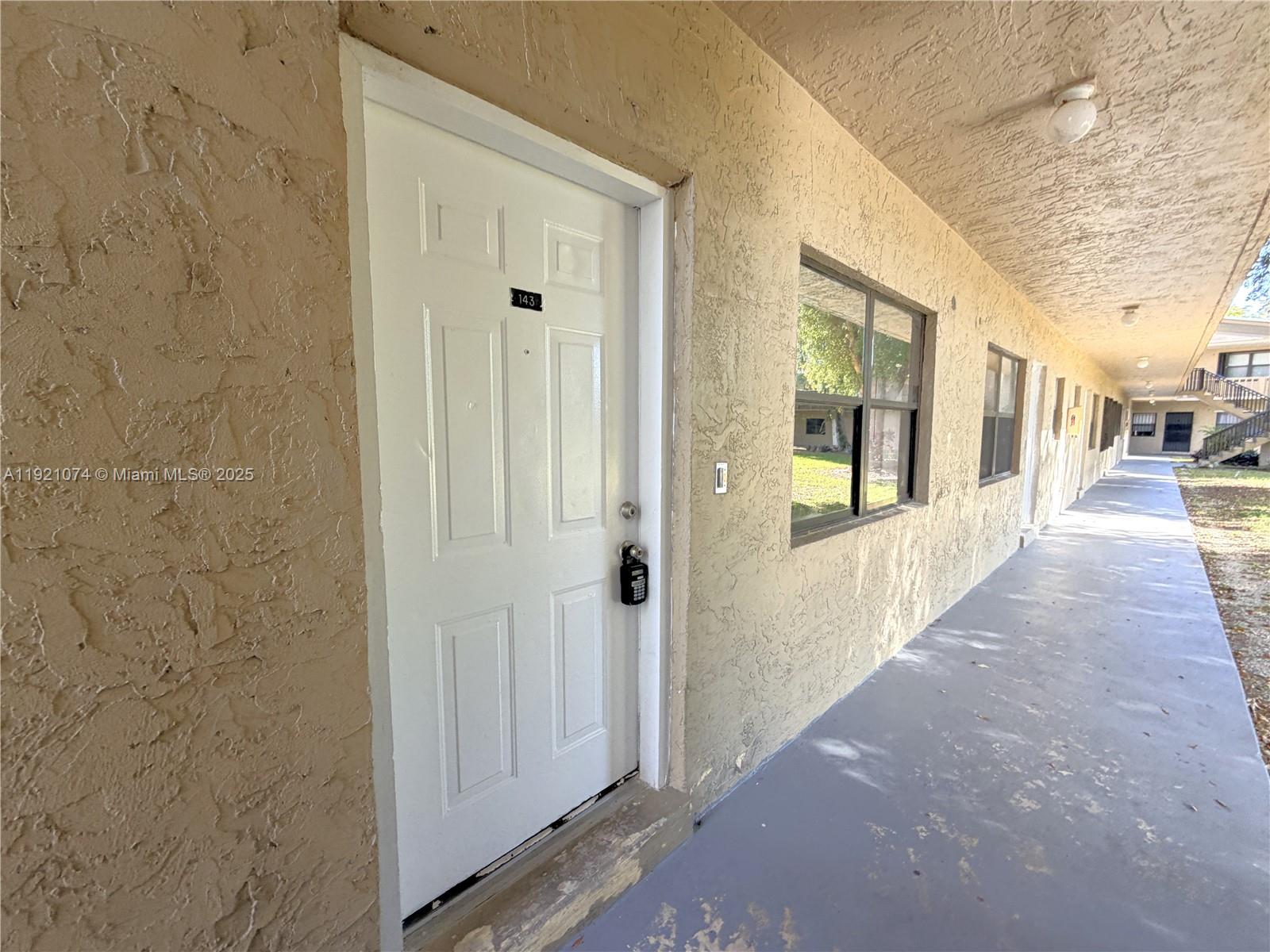 10350 Southwest 220th Street, Unit 143 Cutler Bay, FL 33190 - Photo 2 of 18 a view of a hallway with wooden floor