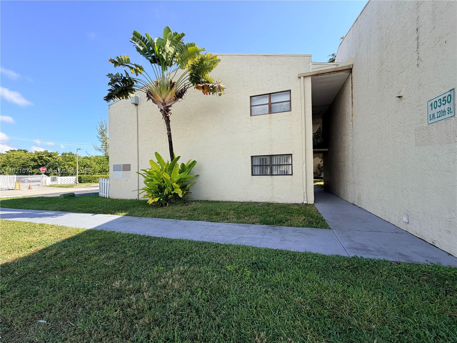 10350 Southwest 220th Street, Unit 143 Cutler Bay, FL 33190 - Photo 3 of 18 a view of a house with a yard