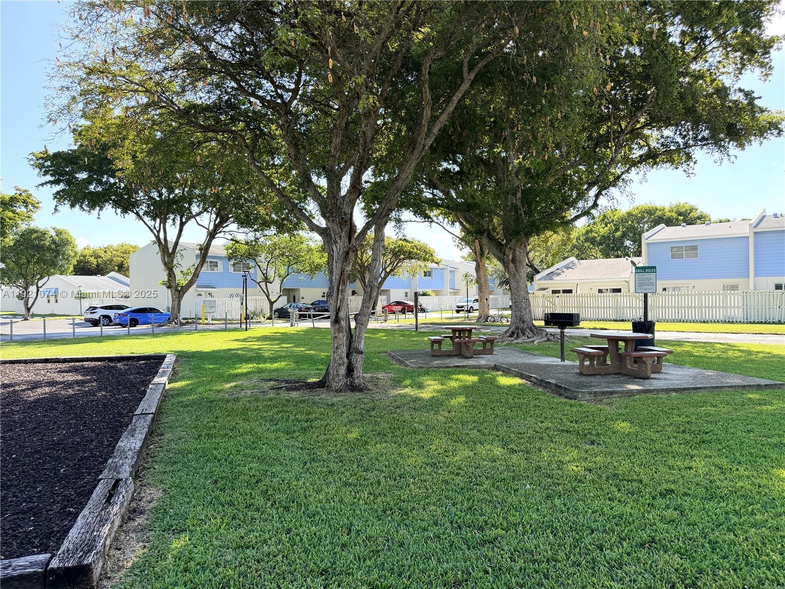 10350 Southwest 220th Street, Unit 143 Cutler Bay, FL 33190 - Photo 8 of 18 a view of a house with swimming pool and a yard
