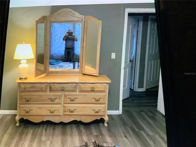a view of bedroom with wooden floor