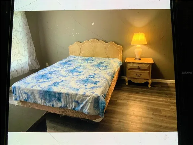 a bedroom with a bed and dresser