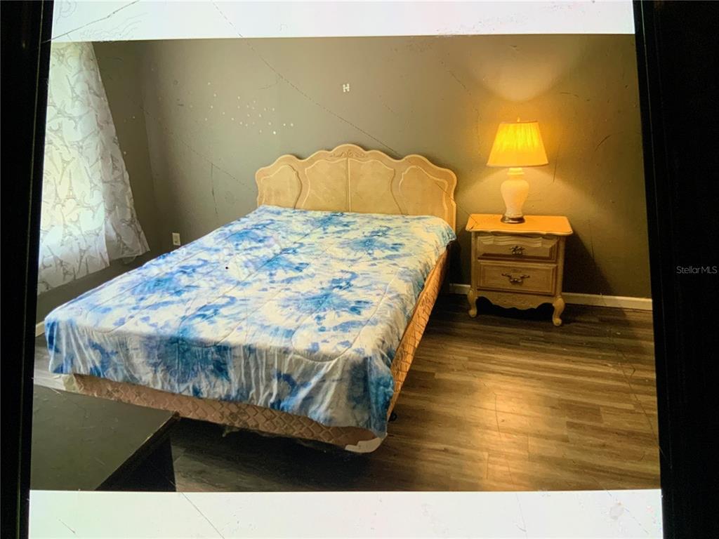13080 Northwest 168th Place Reddick, FL 32686 - Photo 13 of 19 a bedroom with a bed and dresser