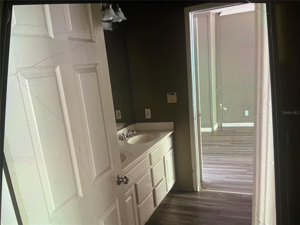 13080 Northwest 168th Place Reddick, FL 32686 - Photo 14 of 19 a bathroom with a sink a toilet and shower