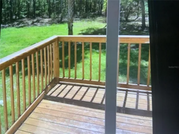 a view of balcony with yard