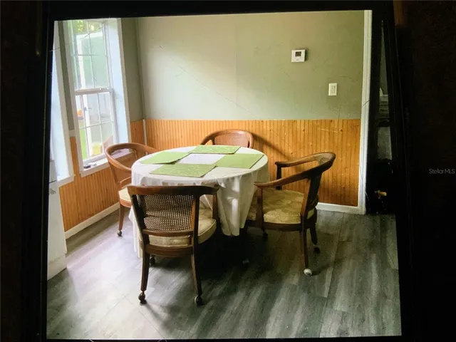 a view of a dining room with furniture and wooden floor