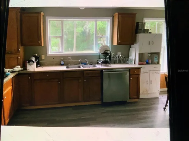 a kitchen with a sink cabinets and a large window