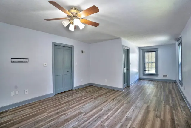wooden floor in an empty room with a window