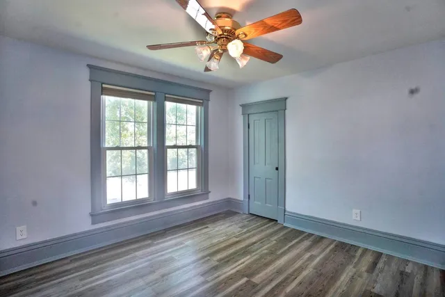 wooden floor in an empty room with a window