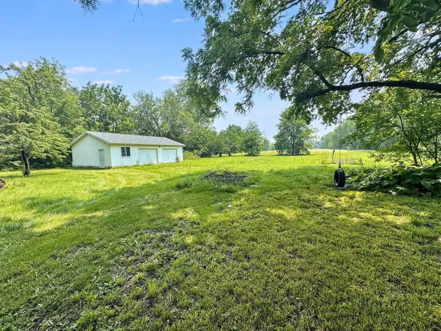 a view of a house with a yard and garage