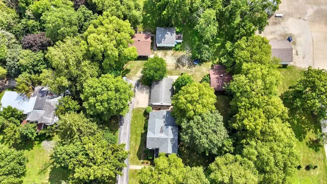 an aerial view of a house with a yard and garden