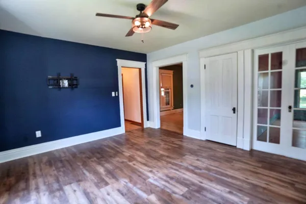 wooden floor in an empty room with a window