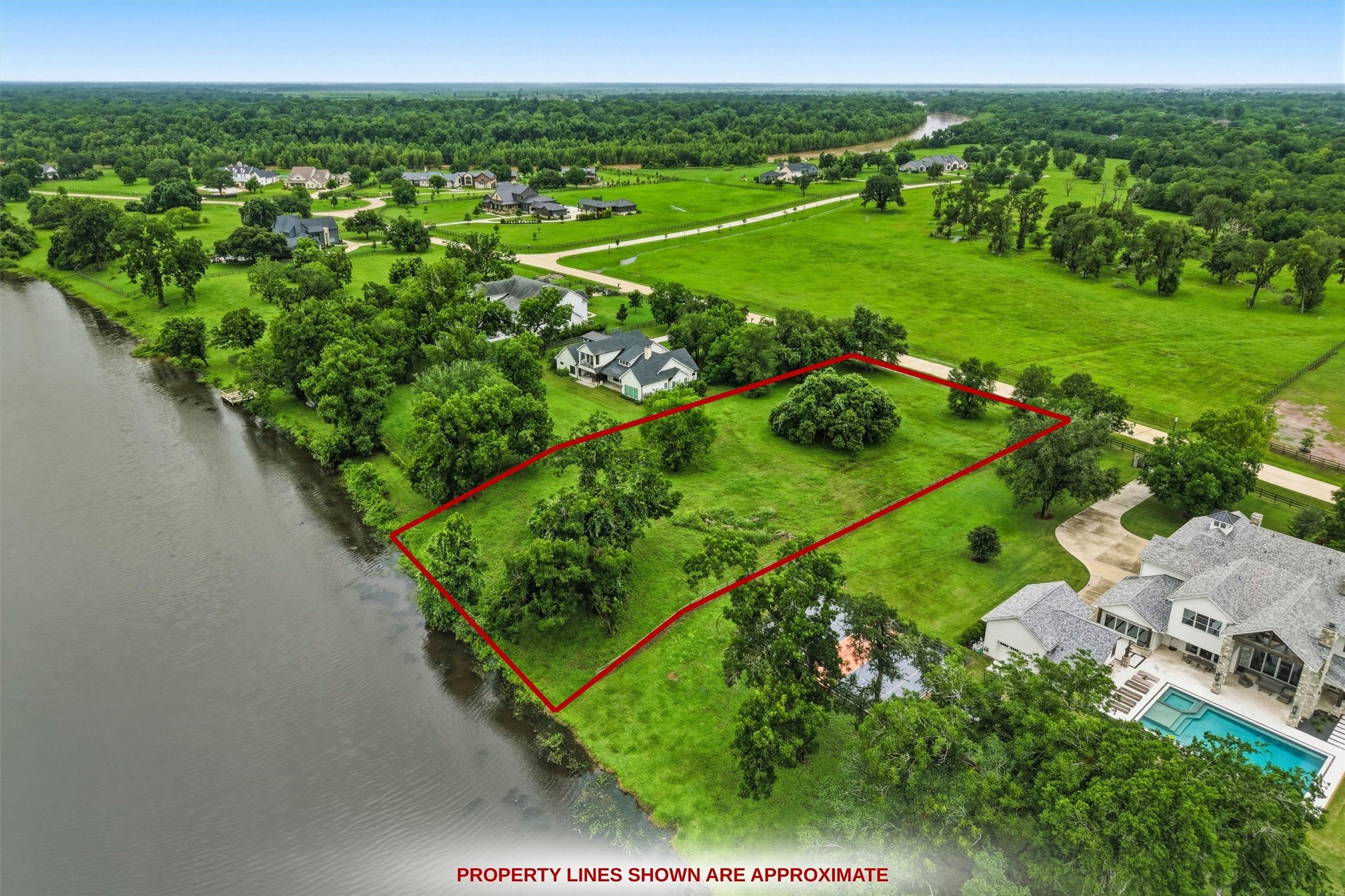 0 Riverlake Road Fulshear, TX 77441 - Photo 5 of 47 Another aerial view highlights the incredible size and waterfront orientation of this remarkable homesite. With over 1.37 acres, there is ample space to design a luxury residence with every amenity imaginable. Buyer to verify dimensions.
