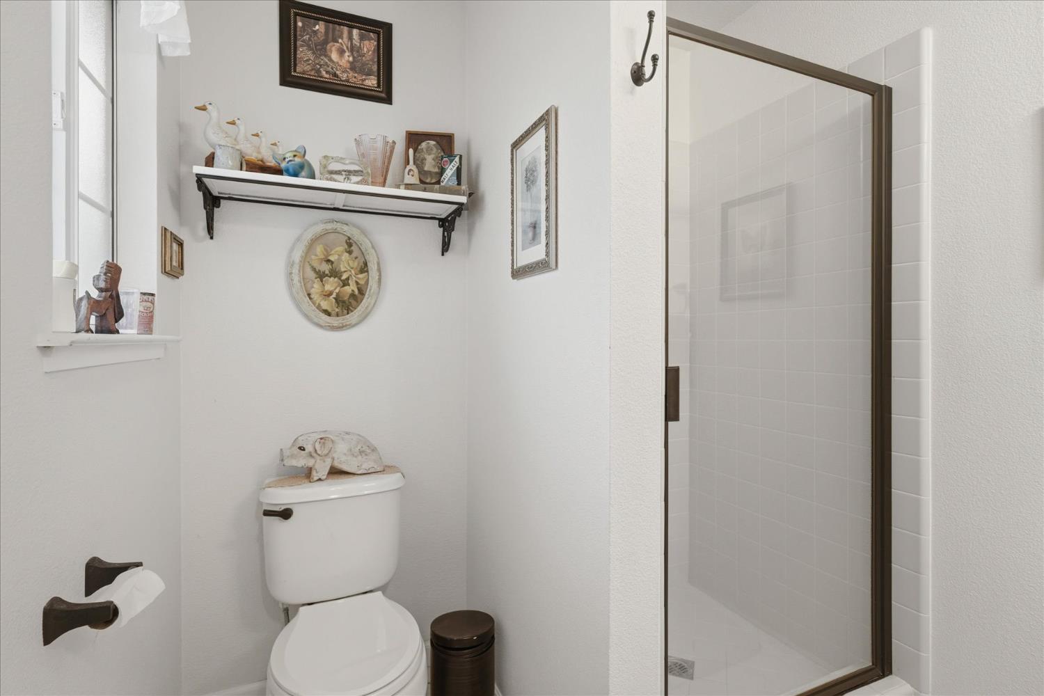 32583 River Knolls Road Coarsegold, CA 93614 - Photo 26 of 63 a white toilet sitting next to a bathroom sink