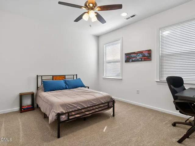 a bedroom with a bed and window