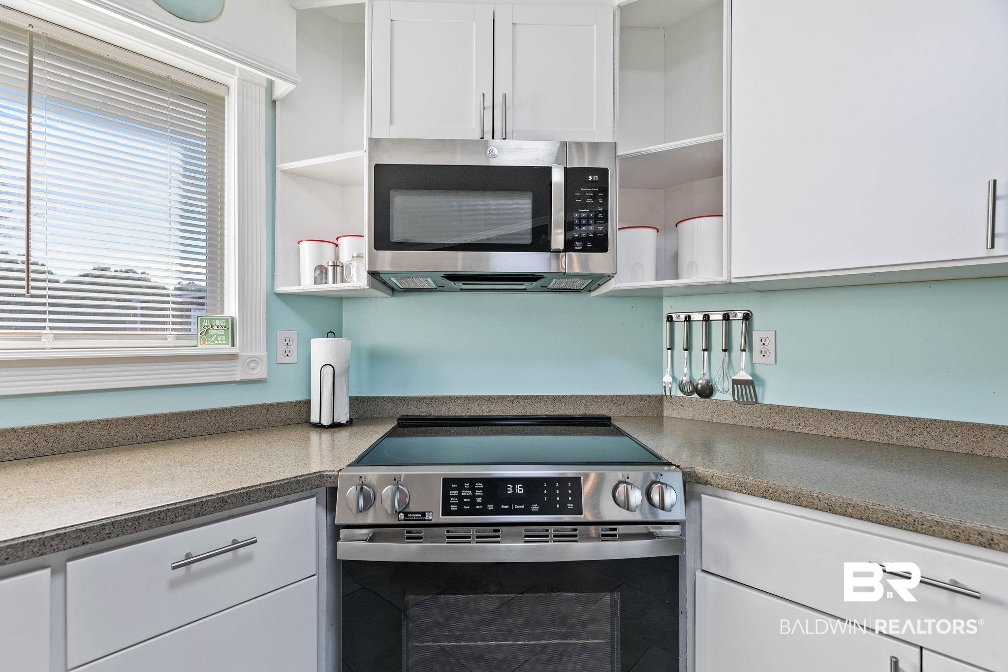 21267 Loop Road Andalusia, AL 36421 - Photo 25 of 72 Kitchen with open shelves, white cabinetry, and stainless steel appliances