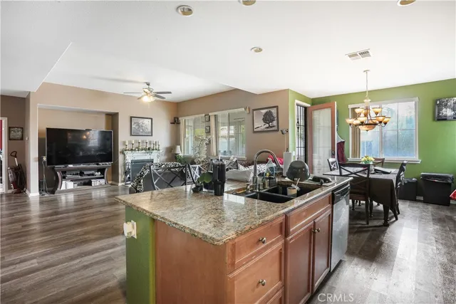 a view of a dining room with furniture a chandelier and wooden floor